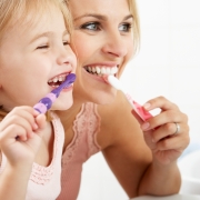 Mother and Daughter Brushing Teeth